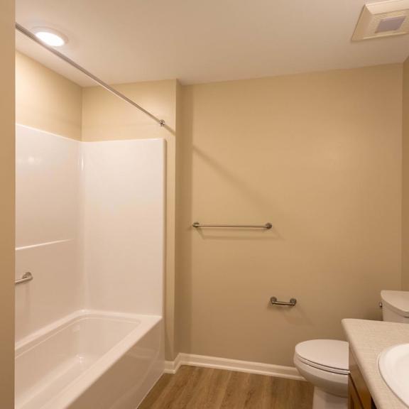 A bathroom with a toilet, sink, and bathtub.