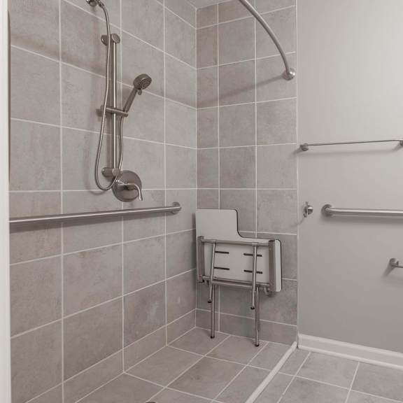 A bathroom with a toilet, sink, and shower.