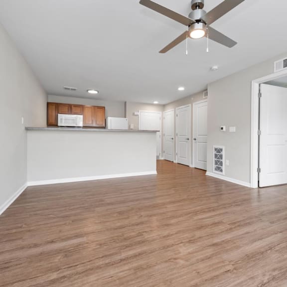 a home office with hardwood floors and a large window