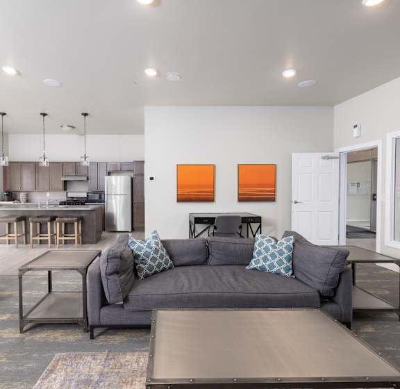 A modern living room with a grey couch and a wooden coffee table.