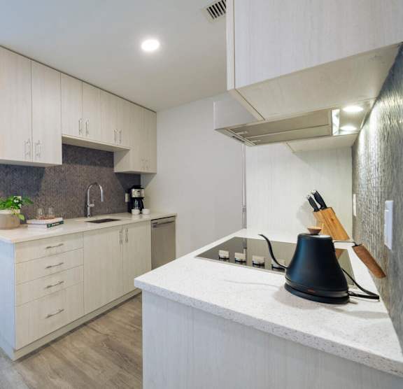 a kitchen with white cabinets and a white counter top