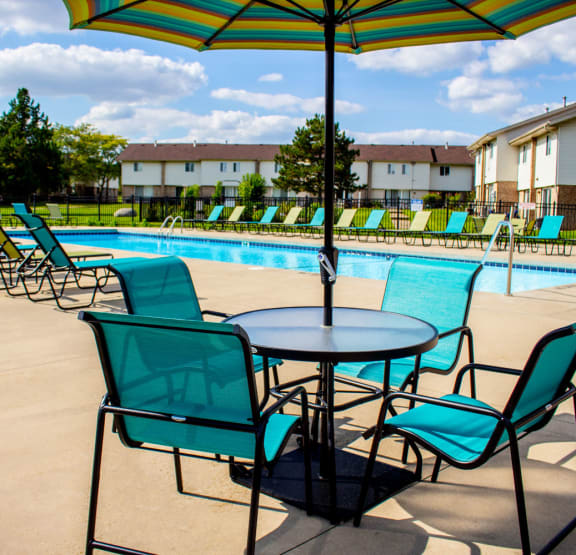 our apartments have a resort style pool with chairs and tables