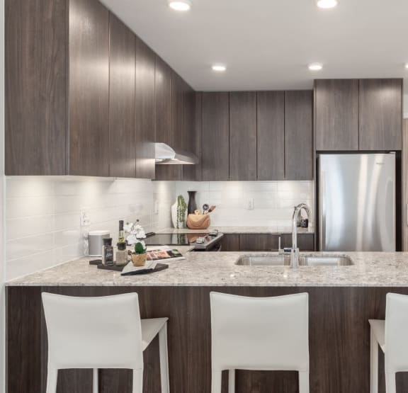 a kitchen with a marble counter top and a sink