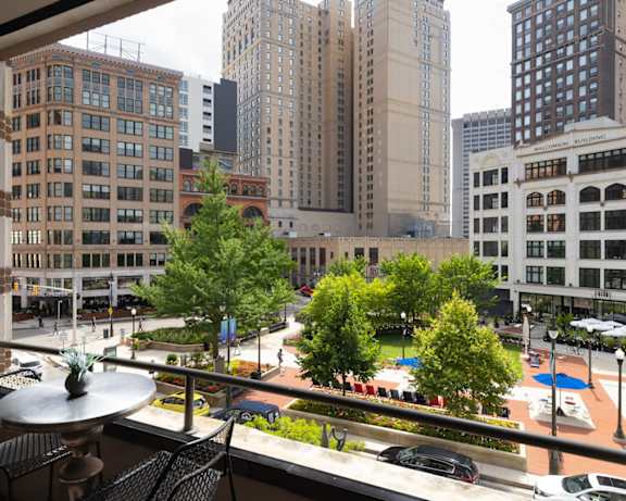 a view of the city from a balcony with a table and chairs