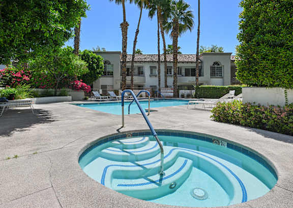 A pool with a slide in the middle of it.