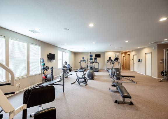 a gym with a lot of exercise equipment in it