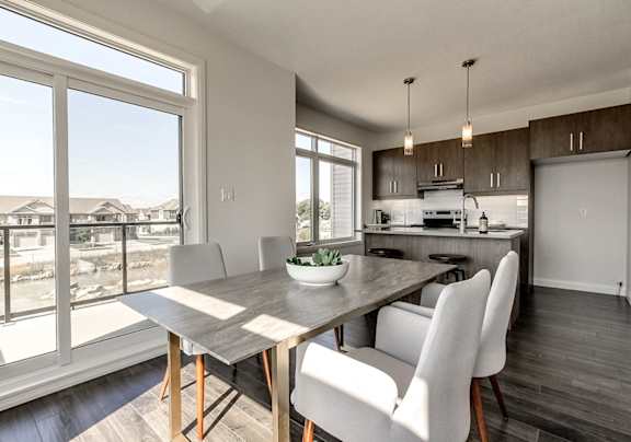 A modern dining room with a large table and chairs.