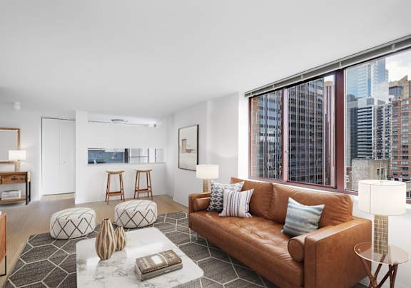 A bathroom with a large window overlooking a cityscape at The Ellington Apartments, New York, NY, 10019