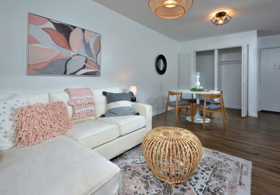 a living room and dining room with a couch and a table at Capital Flats & Magnolia Square Apartments, North Carolina, 27601