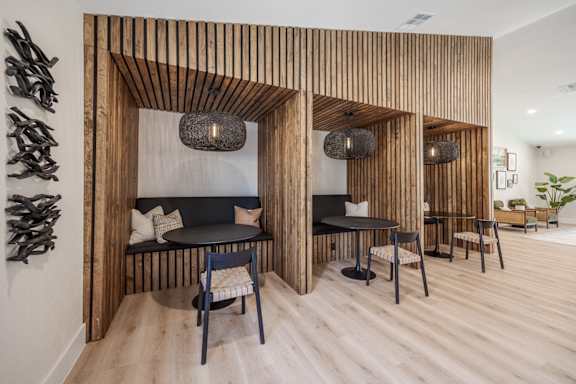 A residential lounge with chairs, tables, and couches at Sage at Green Valley apartments in Henderson, NV