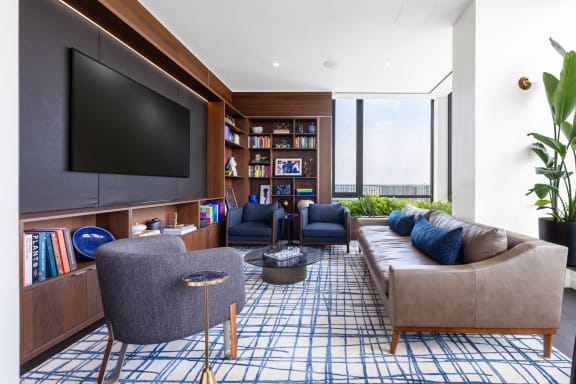 a living room with couches and chairs and a television