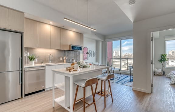A modern kitchen with a white table and chairs at Southpark on Whyte, Edmonton