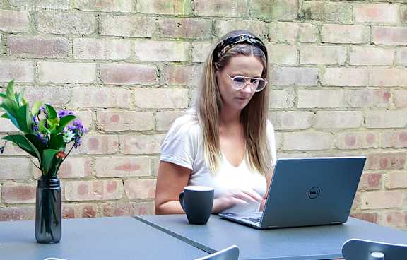 a living room with a green couch and a balcony