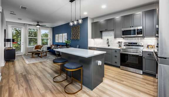 Kitchen with gray cabinets and a white countertop at The Alibi at Lake Lilly, Ocoee, FL, 34761