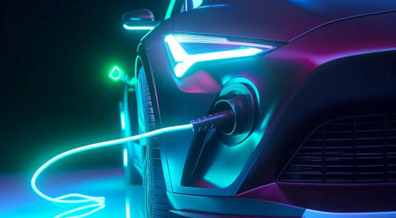 a futuristic car is being charged by a charging cable