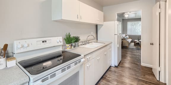a kitchen with white appliances and white cabinets
