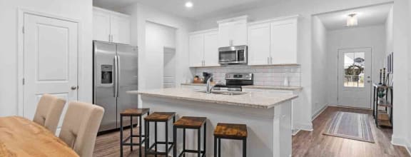 the living room is open to the dining room and kitchen