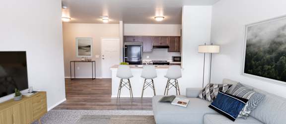 a living room and kitchen with a couch and a table