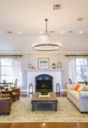 a living room with a fireplace and a couch at The Park at Monterey Oaks, Austin, TX