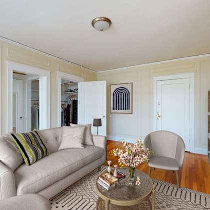 A living room with a couch, chair, and a coffee table.