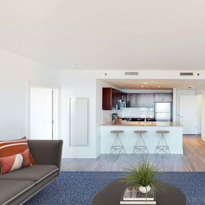 A living room with a couch, a coffee table, and a television.