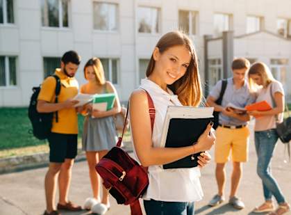 a girl standing in front of a group of students