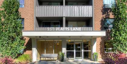 a bench in front of a building at Platts Crossing, London, ON