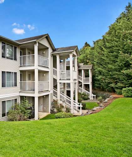 A large two-story apartment building with a balcony on the second floor.