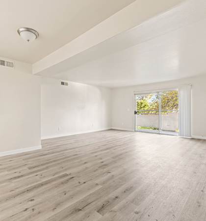A room with wooden floors and white walls.