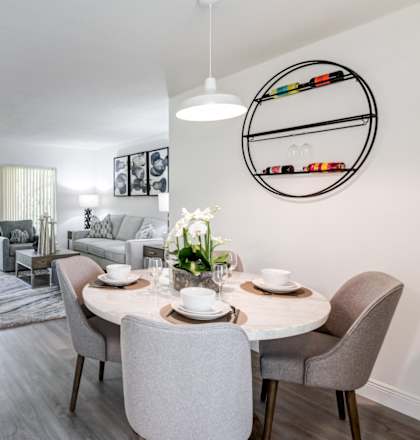 a living room and dining room with a table and chairs