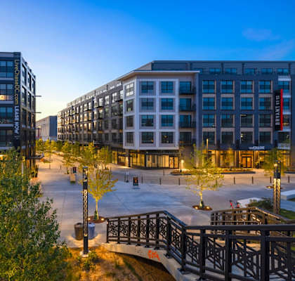 a city street with buildings and trees at night at Coda at Bryant Street, Washington, DC 20002