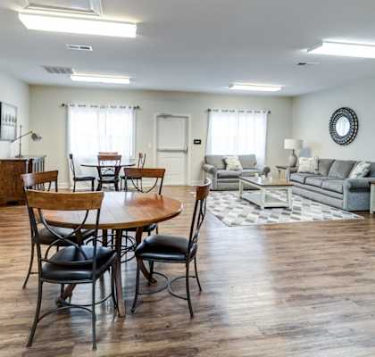 A living room with a wooden table and chairs.