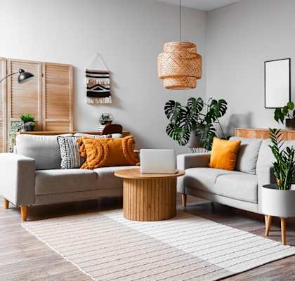 a living room with a couch and a chair and a rug