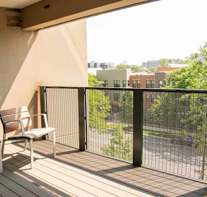 a balcony with two chairs and a view of the city