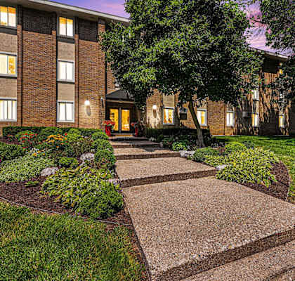 a walkway in front of a brick building