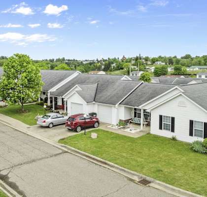 a neighborhood of houses with cars parked in front of them