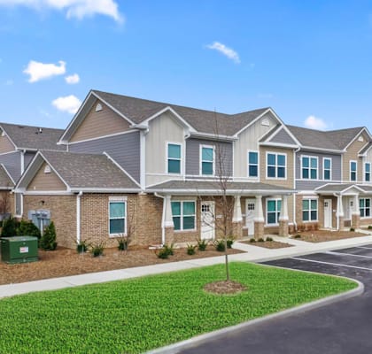 a row of houses with a parking lot in front of them
