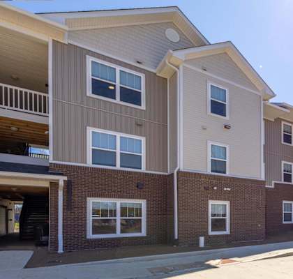 Apartment complex with multiple buildings and balconies.