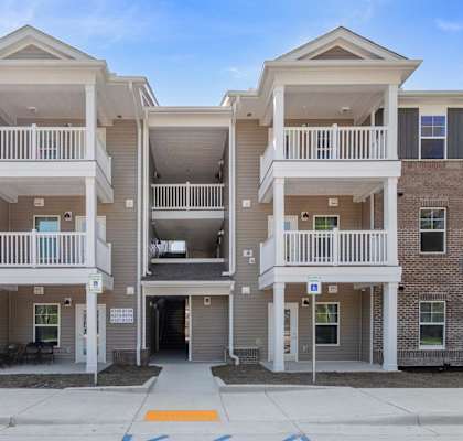 Apartment complex with two buildings and balconies.
