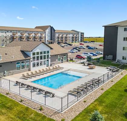 A large building with a pool in front.