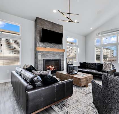 A modern living room with a fireplace and a television.