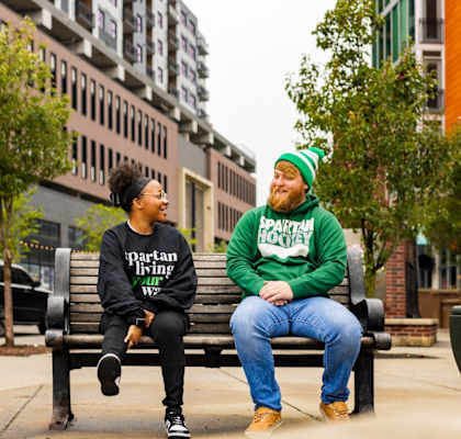 two people sitting on a park bench