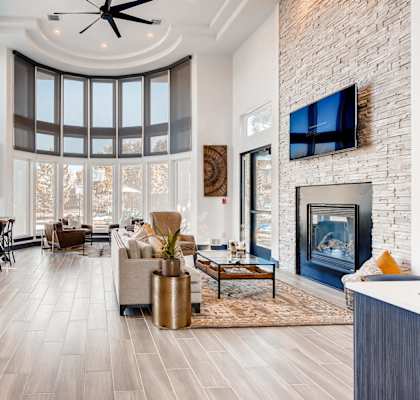 A modern living room with a fireplace and a bar area.