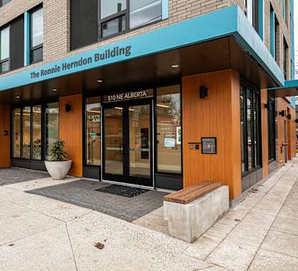 The front of the Ronnie Herndon Building with a blue awning.