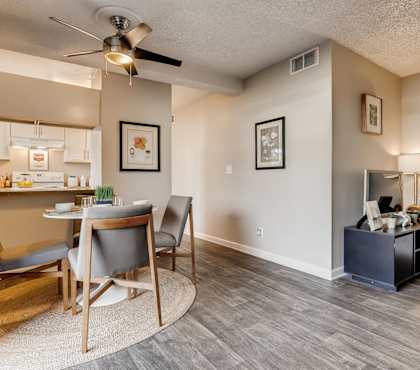 A living room with a grey chair and a wooden table.