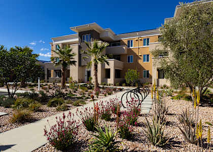 A modern building with a garden in front.