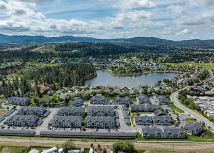 a city from the sky with houses and a lake