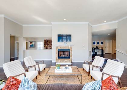 a living room with white furniture and a fireplace at WildForest Apartments, Alabama