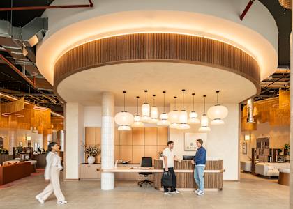 A reception area with people standing and talking.
