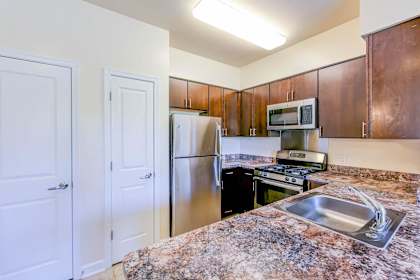 A kitchen with granite countertops and stainless steel appliances.